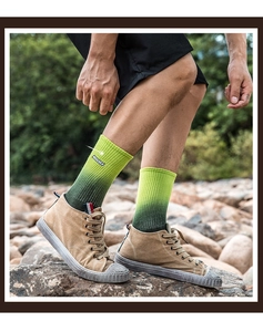 Detail of green and yellow gradient cotton socks with embroidered AURORA logo for outdoors