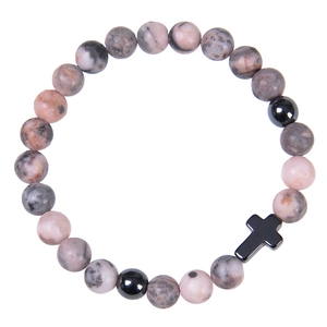 Detailed view of pink zebra stone beads and a black cross charm on an elastic bracelet