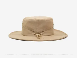Detail view of khaki outdoor hat featuring metal ventilation eyelets and adjustable buckle