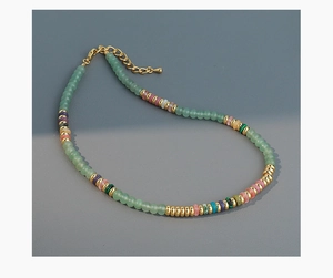 Close-up of multicolor natural stone beaded necklace with gold lobster clasp and chain