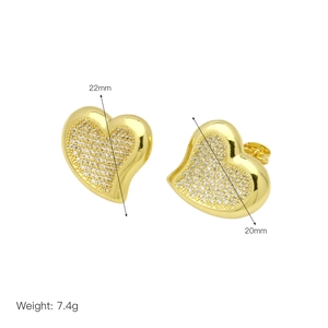 Detail view of gold heart earrings with white cubic zirconia measuring 22mm by 20mm