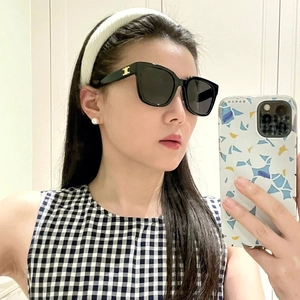 Detail of vintage square sunglasses with golden metal logo on the temple for women