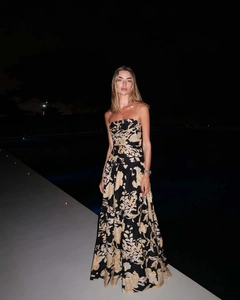 Detail view of the strapless maxi dress featuring vintage floral prints and flowing fabric