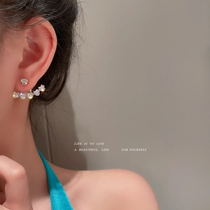 Elegant silver needle heart-shaped zircon earrings with curved sparkling crystals on model
