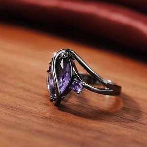 Detail view of marquise-cut purple zircon set in gun black plated vintage ring band