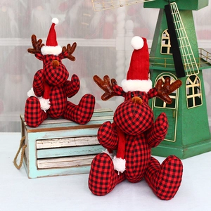 Christmas reindeer plush decor with red black plaid fabric and knit hat on wooden box