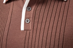 Macro detail of the vertical ribbed knit texture and buttoned polo collar on a brown sweater