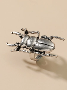 Detailed close-up of retro silver stag beetle ring with intricate insect mandible texture