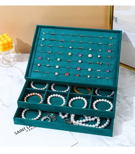 Three-layer dark green velvet jewelry organizer with ring slots and pearl bracelets