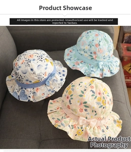 Detail view of cotton floral baby sun hats with ribbon bows in three pastel colors