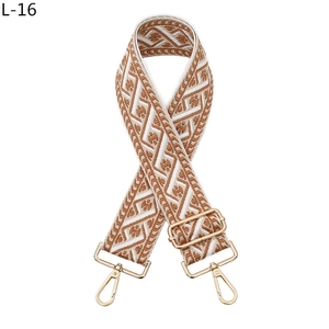 Detail of bohemian geometric jacquard bag strap with gold metal lobster clasps