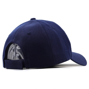 Detail view of navy blue baseball cap back with adjustable velcro strap and cotton texture