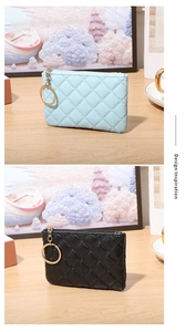 Detailed view of quilted PU leather coin purses with gold keychains on a wooden desk