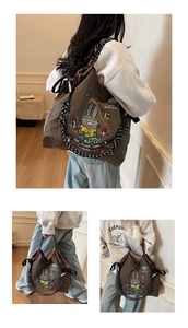 Detail of cartoon rabbit print and dotted rope strap on brown canvas tote bag