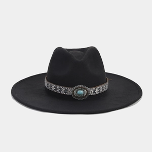 Detail of black wool fedora featuring ethnic woven band and turquoise gemstone accent