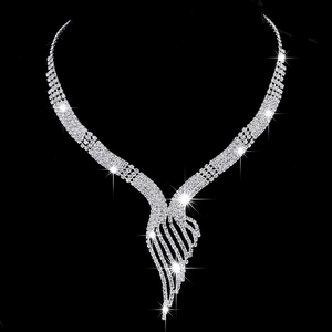 Sparkling silver rhinestone tassel necklace with elegant asymmetric wing design on black background