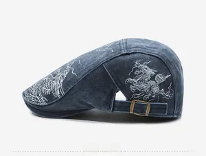 Detailed side view of vintage denim newsboy cap with white dragon embroidery and buckle