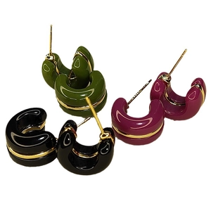 Elegant C-shaped resin stud earrings in black, green, and purple with gold wire inlay