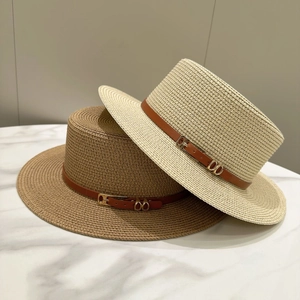 Detail of wide brim straw hats in beige and khaki with decorative leather bands
