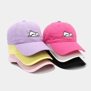 Close-up of colorful cotton baseball caps with cute cartoon duck embroidery detailing