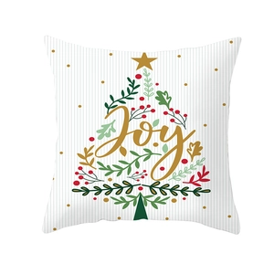 Detail of Christmas pillowcase with Joy slogan, green leaves and berry wreath pattern
