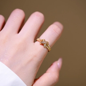 Crossed 18K gold plated ring with marquise and pavé zircon stones on finger