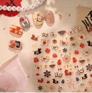 Close-up of embossed Chinese New Year nail art stickers featuring fortune and koi fish