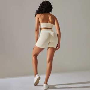 Rear view of off-white seamless ribbed yoga set featuring high-waisted shorts and sports bra
