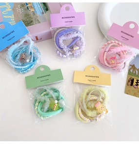 Close-up of handmade candy color flower hair ties with cute cartoon bear accessories