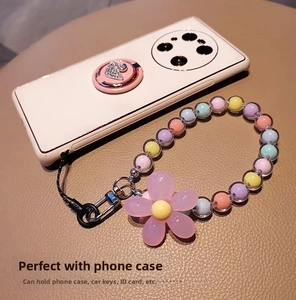 Detail of macaron bead phone charm with pink flower pendant and metal lobster clasp