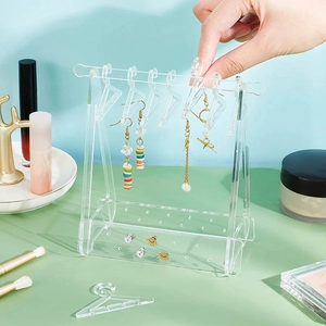 Creative acrylic earring organizer stand with mini hangers in a transparent design