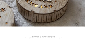 Close-up of wooden LED Christmas ornament with warm light and carved XMAS letters