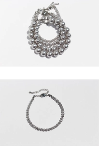Detailed view of silver metallic bead necklaces with lobster clasp and extension chain