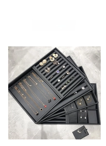 Close-up of black PU leather jewelry tray with multi-compartment storage slots
