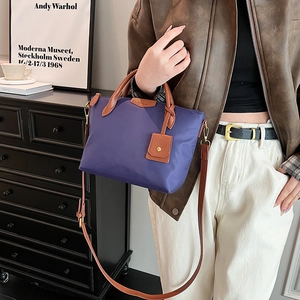 Fashionable purple nylon tote bag with leather handles and crossbody strap for women