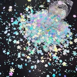 Close-up of holographic PET glitter flakes in snowflake and hexagon shapes for nail art