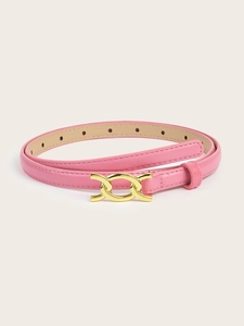 Detail of pink thin belt with gold double-ring metal buckle on a neutral background