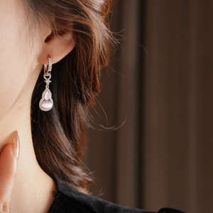 Close-up of a model wearing a zircon opal gourd pendant earring in silver and pink