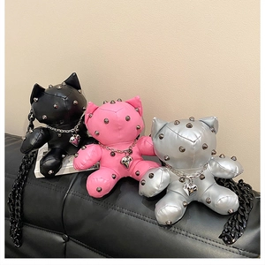 Three punk style cat-shaped crossbody bags in black, pink, and silver with metal studs
