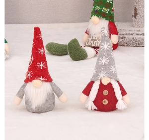 Detail of Christmas gnomes with knitted snowflake hats and white braids for tree decor