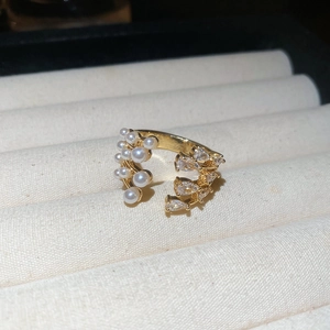 Close-up of vintage multi-layer pearl ring with zircon accents in a velvet jewelry box