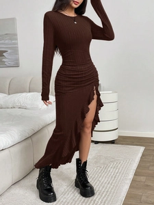 Detail of deep brown ribbed knit dress featuring a ruffled hem and side slit design