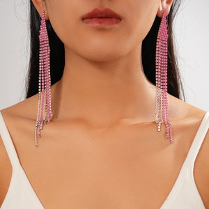 Detailed view of long tassel earrings with pink and clear rhinestones on model