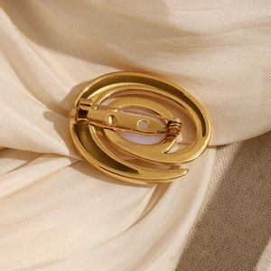 Elegant 18K gold plated conch pearl brooch for women on champagne silk fabric background