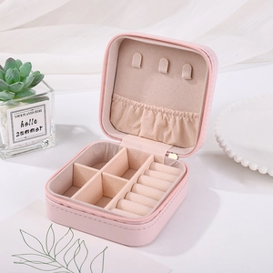Pink leather jewelry box detail showing zipper, necklace hooks and ring storage slots