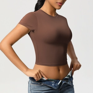 Side view of slim fit brown crop top yoga t-shirt showing elastic fabric and body contour