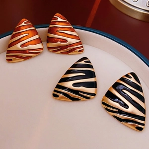 Vintage gold plated triangle earrings with zebra pattern in amber and black enamel