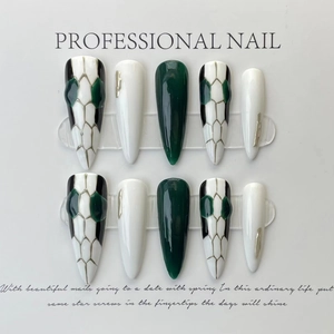 Elegant stiletto press-on nails with luxury snake head design and gold foil accents