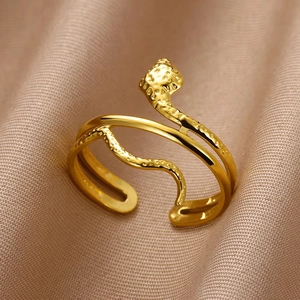 Close-up of golden vintage snake ring with dual bands and textured snake head detail