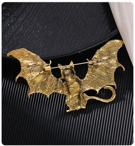 Detail view of the vintage gold bat cat brooch showing back pin safety fastener